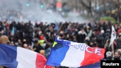 Flags are seen during a demonstration as part of the 10th day of nationwide strikes and protests against French government's pension reform in Paris, France, March 28, 2023.