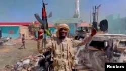 A member of the RSF forces walks around the destroyed Air Defence Forces command site in Khartoum, Sudan, in this screengrab obtained from a social media video on June 14, 2023. (RSF via Twitter/via Reuters)