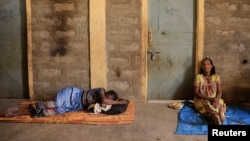 FILE - People displaced due to the fighting rest outside their shelter at the Abi Adi camp for internally displaced in Abi Adi, Tigray region, Ethiopia, June 24, 2023.