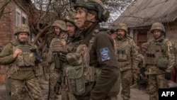 Ukrainian infantry soldiers of the 23rd Mechanized Brigade wait to head toward the front line in the Avdiivka direction, in Ukraine's Donetsk region, on April 3, 2024. (Roman Pilipey/AFP)