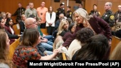 Oakland County Prosecutor Karen McDonald, right, shakes hands with victims' parents after Jennifer Crumbley was found guilty on four counts of involuntary manslaughter in an Oakland County court on Feb. 6, 2024, in Pontiac, Michigan. (Mandi Wright/Detroit Free Press via AP/Pool)
