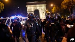 Police officers patrol in front of the Arc de Triomphe on the Champs Elysees in Paris, July 1, 2023.