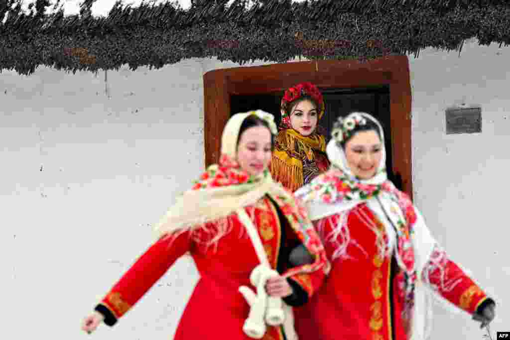 Girls, wearing Ukrainian traditional clothes, take part in Christmas celebrations in the village of Pyrogove, near Kyiv, Dec. 25, 2023, amid Russian invasion in Ukraine. 