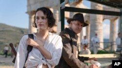 This image released by Lucasfilm shows Phoebe Waller-Bridge, left, and Harrison Ford in a scene from "Indiana Jones and the Dial of Destiny."