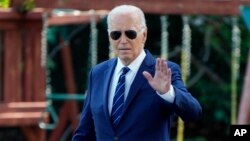 President Joe Biden waves to the media as he walks to board Marine One, July 15, 2024, on the South Lawn of the White House in Washington.