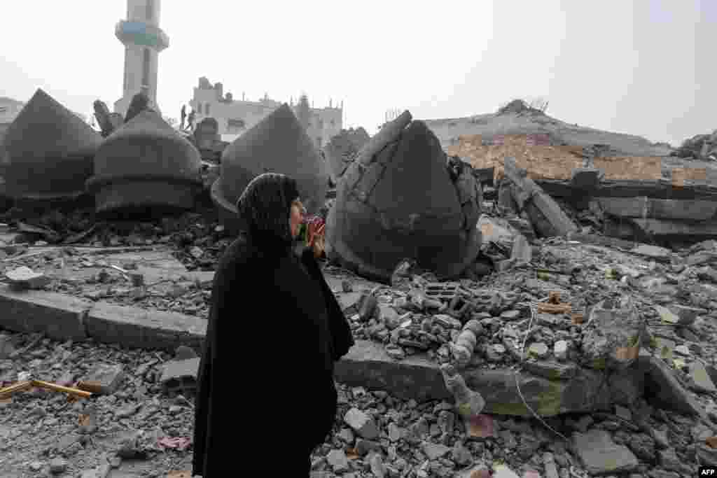 A woman walks near the Al-Faruq mosque, leveled by Israeli bombardment in Rafah in the southern Gaza Strip, Feb. 25, 2024.