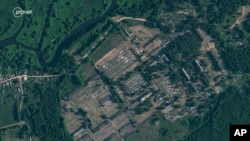 This satellite image provided by Planet Labs PBC, taken June 30, 2023, shows recent construction of tents at a former military base outside the Belarusian town of Osipovichi.