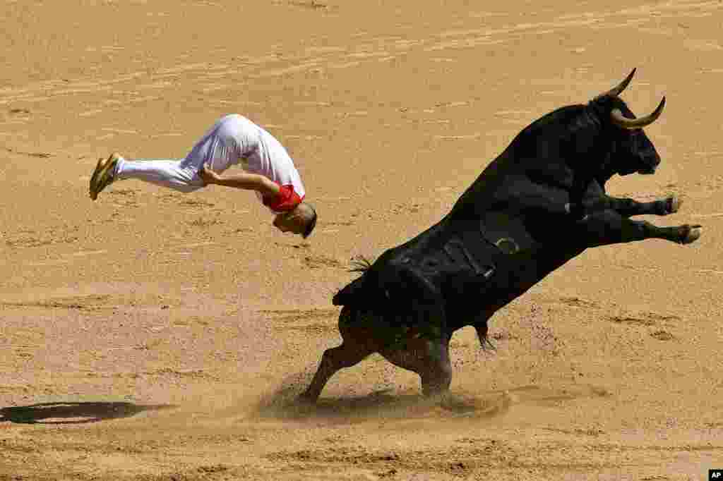 A ''Recortador'' jumps over a bull in the bull ring during the Recortadores festival at the San Fermin fiestas in Pamplona, northern Spain.