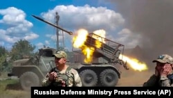 Russian soldiers fire from the BM-21 "Grad" self-propelled 122mm multiple rocket launcher in an undisclosed location in Ukraine, July 1, 2024.