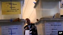 FILE - An electoral official checks ballot boxes in Domboshawa, near the Zimbabwean capital Harare, April 19, 2008. Zimbabwe's Electoral Court ruled Savior Kasukuwere is ineligible to appear on the paper ballot in the August 2023 general election.