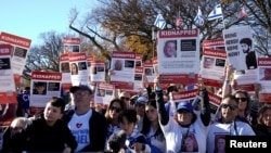 FILE - Jewish Americans and supporters of Israel hold signs as they gather in solidarity with Israel and protest against antisemitism during a rally on the National Mall in Washington, Nov. 14, 2023.