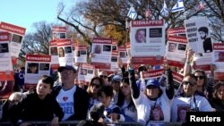 FILE - Jewish Americans and supporters of Israel hold signs as they gather in solidarity with Israel and protest against antisemitism during a rally on the National Mall in Washington, Nov. 14, 2023.