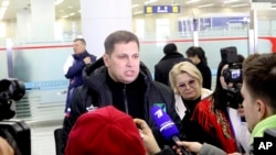 A Russian tourist speaks to the media as a group of Russian tourists, likely the first foreign travelers from any country to enter North Korea since the pandemic arrive at the Pyongyang International Airport in Pyongyang, North Korea, Feb. 9, 2024. 