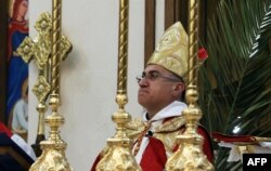 FILE - Iraqi Archbishop Bashar Warda, the Chaldean Archbishop of Irbil, leads a mass at Saint Joseph church in Irbil, the capital of the autonomous Kurdish region of northern Iraq, April 5, 2020.