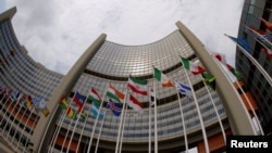 FILE - The Iranian and other flags flutter in front of the International Atomic Energy Agency (IAEA) organization's headquarters in Vienna, Austria, June 5, 2023. 
