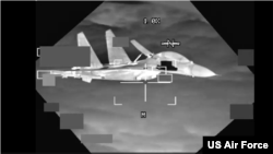 A People’s Republic of China J-11 aircraft is shown in this screen grab from U.S. Air Force B-52 video on Oct. 24, 2023. The U.S. Indo-Pacific Command said the PRC pilot "flew in an unsafe and unprofessional manner," and flew within 10 feet of the B-52.