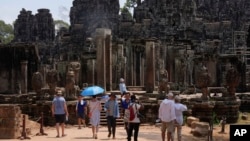 Khách du lịch tham quan đền Bayon tại quần thể đền Angkor Wat ở tỉnh Siem Reap, Campuchia. Đài Loan đang cân nhắc cảnh báo công dân về những rủi ro khi đi du lịch đến các quốc gia có quan hệ chặt chẽ với Trung Quốc như Lào và Campuchia.
