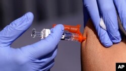 FILE - A patient gets a flu vaccine Oct. 28, 2022, in Lynwood, Calif. 