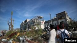 People look at damages caused by Hurricane Otis in Acapulco, Mexico, Oct. 26, 2023.