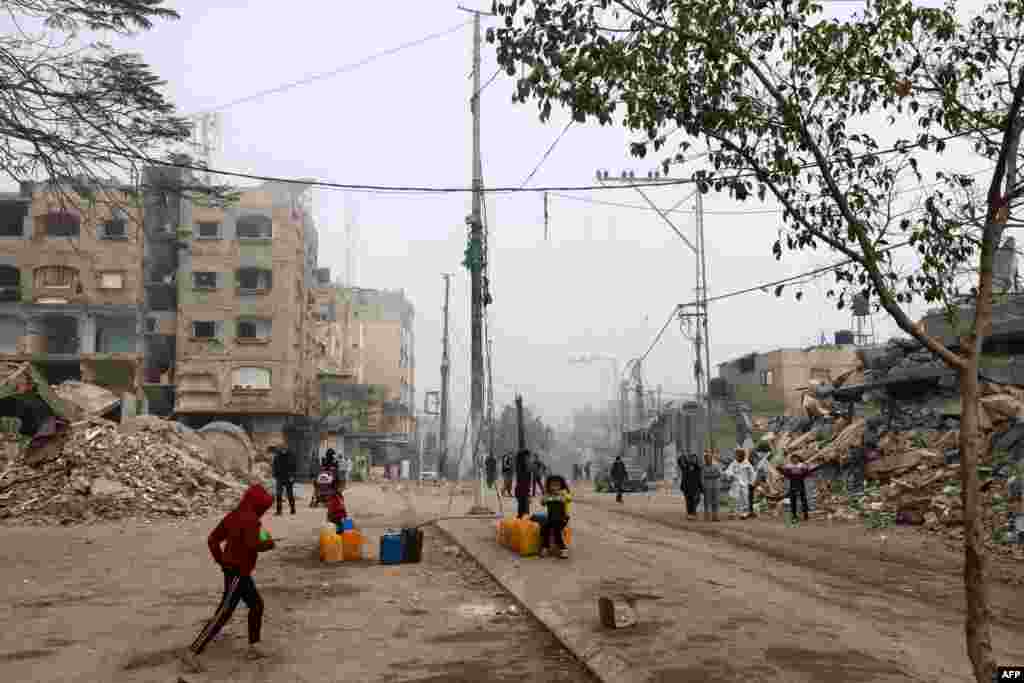 Children fill jerrycans with water in Rafah in the southern Gaza Strip, Feb. 25, 2024.