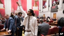 Former Rep. Justin Jones, D-Nashville, raises a fist as he walks to his desk to collect his belongings after his expulsion from the legislature, April 6, 2023, in Nashville, Tenn.