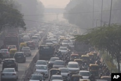 FILE - Commuters drive amidst morning haze and toxic smog in New Delhi, India, Wednesday, Nov. 17, 2021. (AP Photo/Manish Swarup)