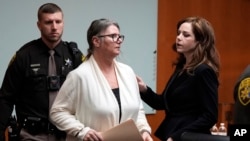 Jennifer Crumbley looks to her attorney Shannon Smith as she is escorted away, Feb. 5, 2024, in Pontiac, Michigan.