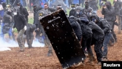 Protesters attend a demonstration called by the collective 'Bassines Non Merci' against the 'basins' on the construction site of new water storage infrastructure for agricultural irrigation in western France, in Sainte-Soline, France, March 25, 2023. 