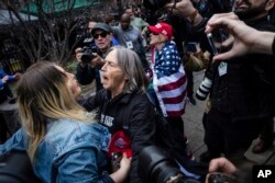 Protesters argue across the street from the Manhattan District Attorney's office in New York, April 4, 2023.