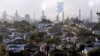 FILE - Smoke billows out of a chimney stack of steel works factories in Port Kembla, south of Sydney, Australia, July 2, 2014.