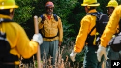 Wildland firefighter instructor James Klungness-Mshoi, center, gives instructions to students during a wildland firefighter training, June 9, 2023, in Hazel Green, Alabama.