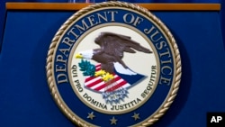 FILE - The U.S. Department of Justice seal in Washington, Nov. 28, 2018. The Justice Department said on Sept. 21, 2023, that a contractor for the U.S. government who is originally from Ethiopia was arrested on espionage charges.