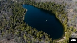 An aerial view of Crawford Lake, near Milton, Ontario, April 12, 2023. Scientists believe the lake's well-preserved sediment layers serve as a reference for a proposed new geological chapter in Earth history, defined by changes wrought by human activity.