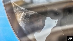 A survivor of latest tragical shipwreck looks out from a bus that will transfer him to Athens with other migrants and refugees at the port of Kalamata, Greece, June 16, 2023.