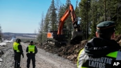 Finland's border guards stay at construction site of the border fence between Finland and Russia, near Pelkola border crossing point in southeastern Finland, April 14, 2023.