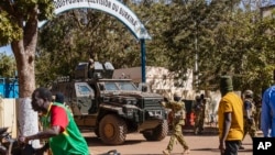 FILE - Burkina Faso mutinous soldiers guard the entrance of the national television station in Ouagadougou, Jan. 24, 2022. 