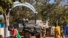 FILE - Burkina Faso mutinous soldiers guard the entrance of the national television station in Ouagadougou, Jan. 24, 2022. Human Rights Watch has criticized the country for omitting human rights abuses in a report to an African human rights commission.