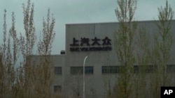 FILE - A Volkswagen factory sits on the outskirts of Urumqi in in western China's Xinjiang Uyghur Autonomous Region on April 22, 2021. 