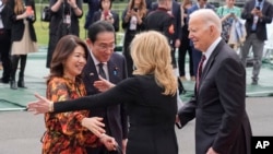 U.S. President Joe Biden, far right, and first lady Jill Biden greet, second from right, greet Japanese Prime Minister Fumio Kishida, second from the left, and his wife Yuko Kishida upon their arrival at the White House in Washington, April 9, 2024