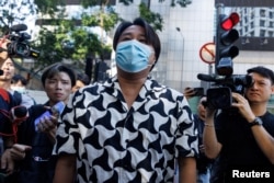 Derek Yuen Mi-chang, son of Elmer Yuen, one of the eight overseas activists wanted by the police, leaves from the police station after being taken to the police station for investigation in Hong Kong, China, July 24, 2023.