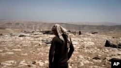 FILE - A Palestinian stands Aug. 9, 2023, in al-Baqa village, from which residents fled after settlers set up an outpost in June. The West Bank Protection Consortium says hundreds of Palestinians have been displaced by settler violence since the October 7 Hamas attacks on Israel.