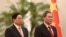 Vietnam's Prime Minister Pham Minh Chinh, left, and Chinese Premier Li Qiang listen to national anthems during a welcome ceremony in the Great Hall of the People in Beijing, June 26, 2023. (Pool photo via AP)