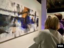 Visitors walk through the exhibit "What Palestine Brings to the World," at the Arab World Institute in Paris, which runs through Nov. 19, 2023. (Lisa Bryant/VOA)