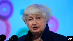 FILE - U.S. Treasury Secretary Janet Yellen addresses a press conference in Gandhinagar, India, July 16, 2023. Yellen will soon travel to China to discuss fair competition in clean energy industries.