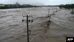This picture shows a view of the overflooded Yongding river, after heavy rains in Mentougou district in Beijing on July 31, 2023.