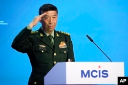 FILE - Chinese Defense Minister Li Shangfu salutes as he arrives to deliver his speech in Moscow, Russia, Aug. 15, 2023. Li has not been seen in public since August 25.
