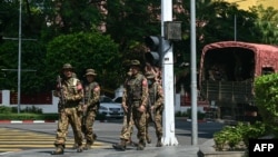 Members of the Myanmar's military security force patrol a street during a "silent strike" to protest and to mark the third anniversary of the military coup in Yangon, Feb. 1, 2024.