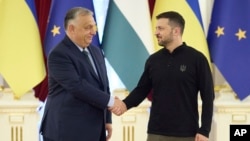 Ukrainian President Volodymyr Zelenskyy, right, welcomes Hungarian Prime Minister Viktor Orban in Kyiv, Ukraine, July 2, 2024. (Ukrainian Presidential Press Office via AP)