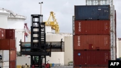 A worker moves containers at the compound of ports operator DP World at Port Botany in Sydney, Nov. 13, 2023. Major ports handling 40% of Australia's freight trade have resumed operations, leading operator DP World said. 