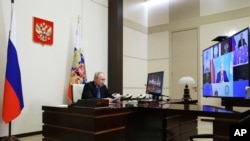 Russian President Vladimir Putin chairs the Security Council meeting via videoconference at the Novo-Ogaryovo State residence outside Moscow, Feb. 13, 2024. (Alexander Kazakov, Sputnik, Kremlin Pool Photo via AP)
